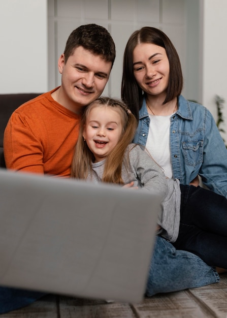 Medium shot family with laptop