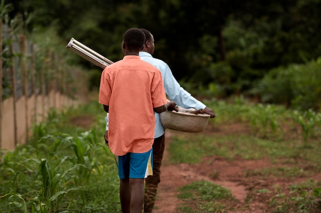 Medium shot farmers in nature