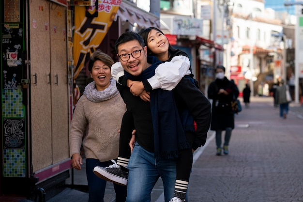 Free photo medium shot father carrying girl