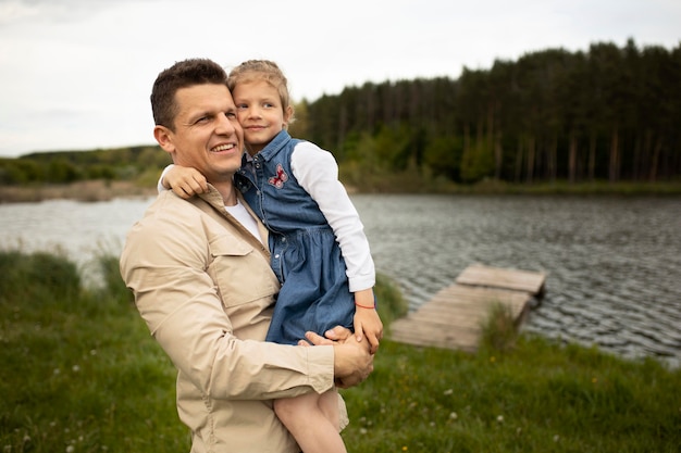 Medium shot father holding child