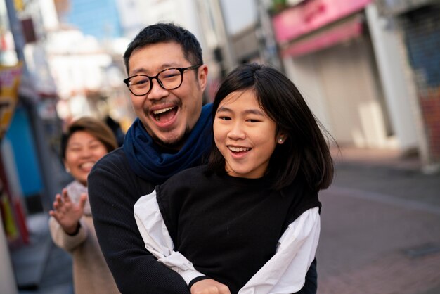 medium shot father holding girl