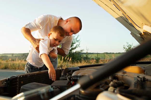 Free photo medium shot father holding kid up