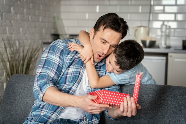 Free photo medium shot father holding present