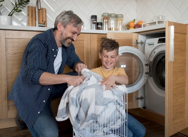 Medium shot father and kid doing laundry