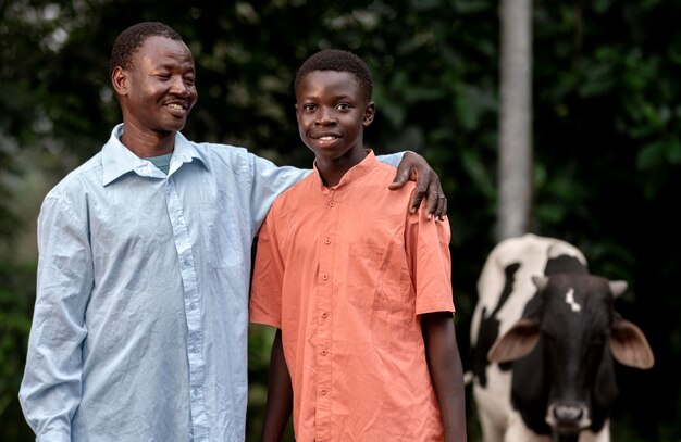 Medium shot father and kid with cow