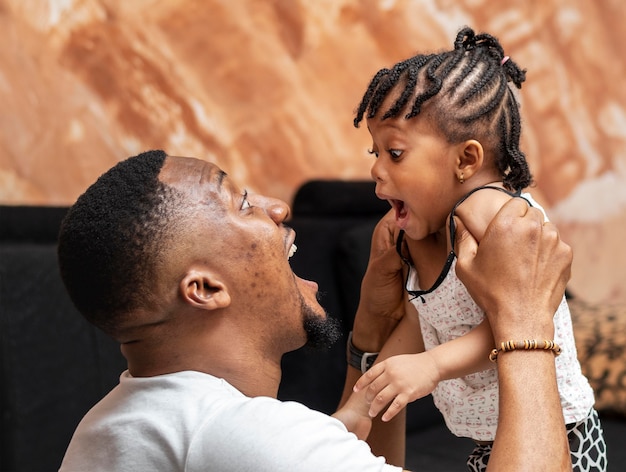 Medium shot father playing with girl