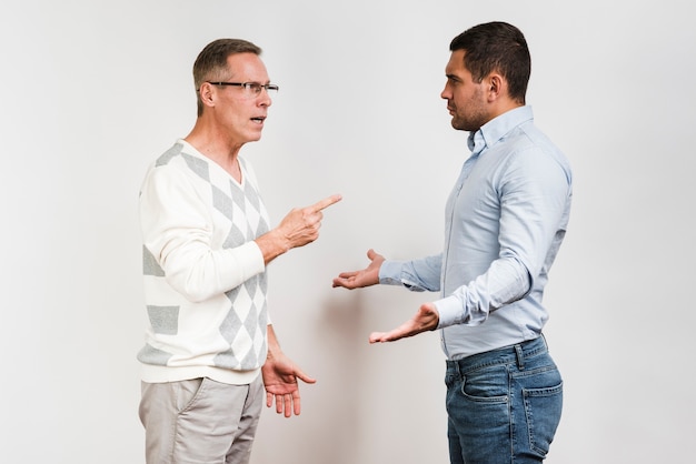 Medium shot of father and son arguing