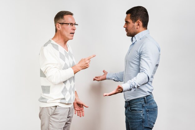 Medium shot of father and son arguing