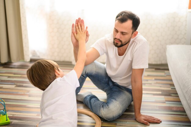 Medium shot father and son high five