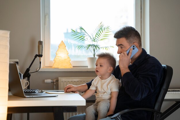 Medium shot father working with kid at home