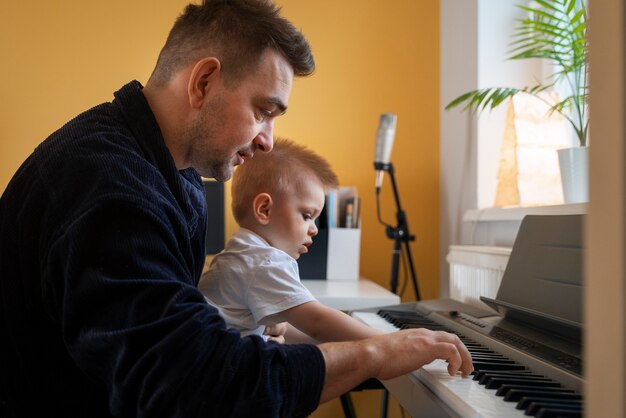 Medium shot father working with kid at home