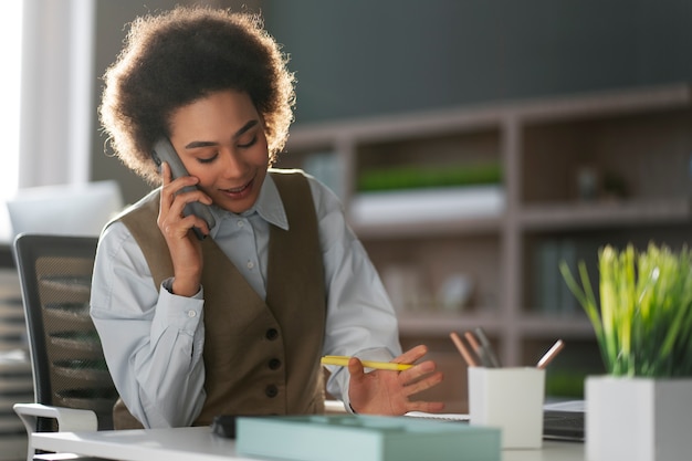 Medium shot female economist holding smartphone