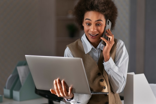 Medium shot female economist working on laptop