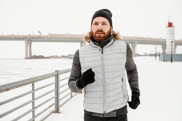 Medium shot fit man running outdoors