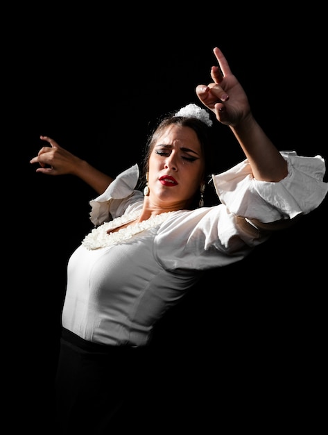 Medium shot flamenca dancing with hands up