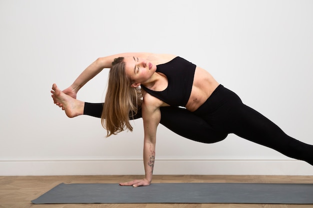 Medium shot flexible woman stretching