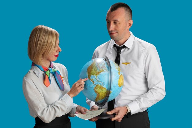 Medium shot  flight attendants with globe