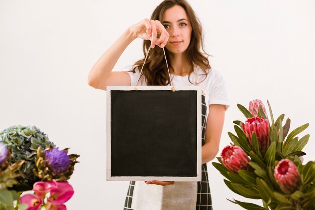 Medium shot florist holding a black board