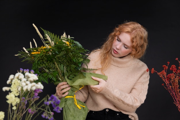 Medium shot florist holding bouquet