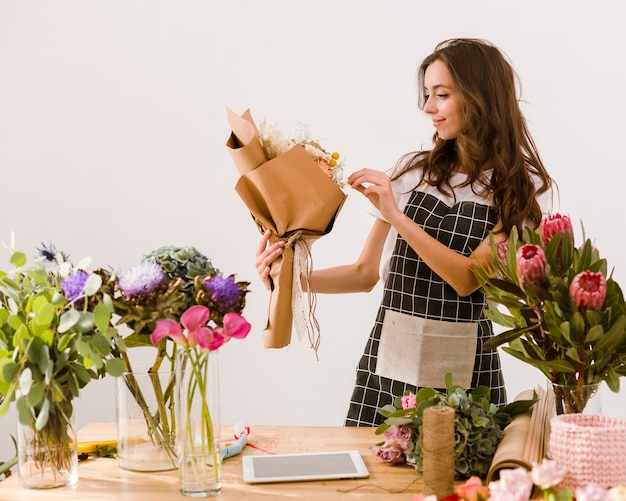 Medium shot florist making a beautiful bouquet