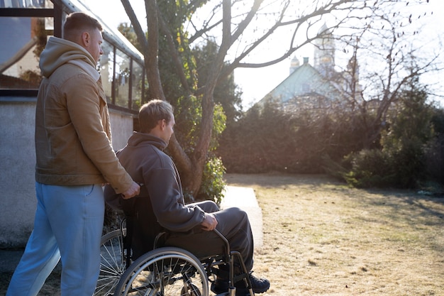 Medium shot friend helping disabled man