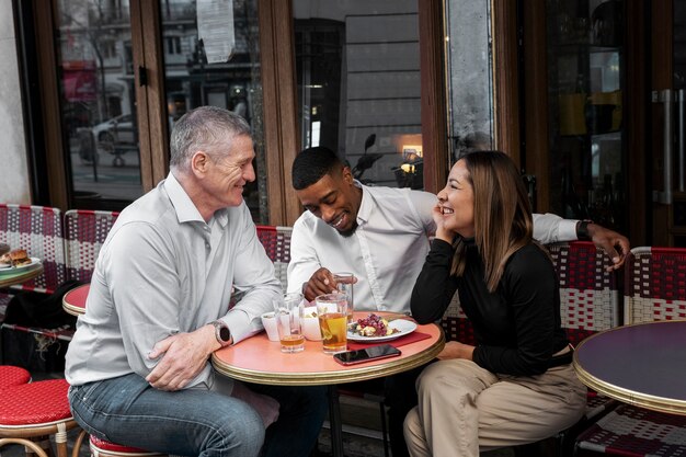 Medium shot friends chatting at bistro