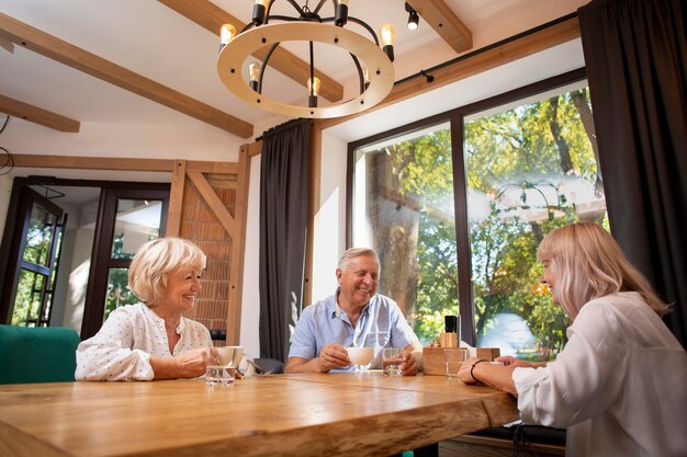 Medium shot friends chatting indoors