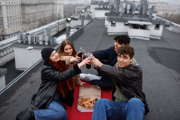 Medium shot friends clinking bottles