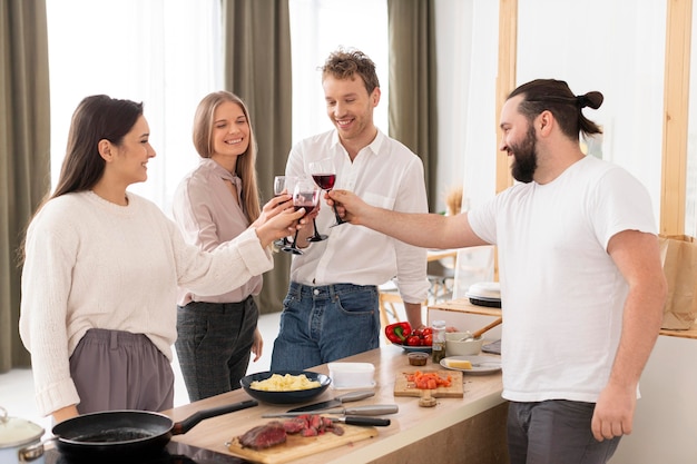 Medium shot friends clinking glasses