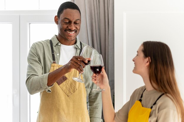 Medium shot friends clinking glasses