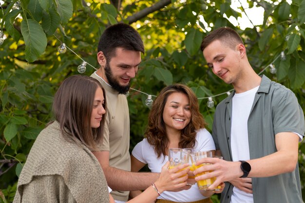 Medium shot friends clinking glasses