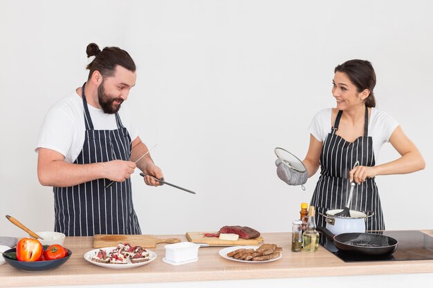 Medium shot friends cooking together