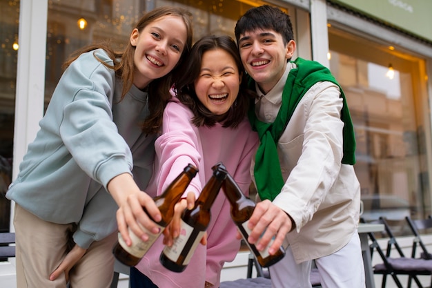 Medium shot friends drinking kombucha