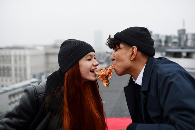 Medium shot friends eating pizza