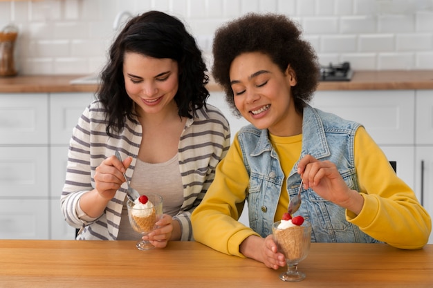 Бесплатное фото Друзья среднего плана едят вкусное мороженое