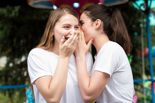 Medium shot friends gossiping outside