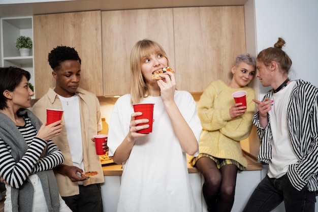 Medium shot friends holding drinks at party