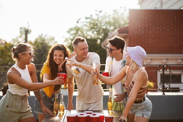 Medium shot friends holding drinks at party