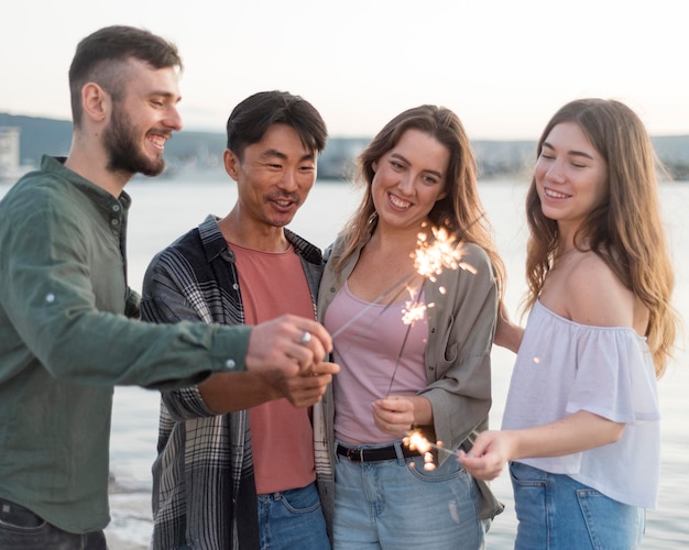 Medium shot friends holding fireworks