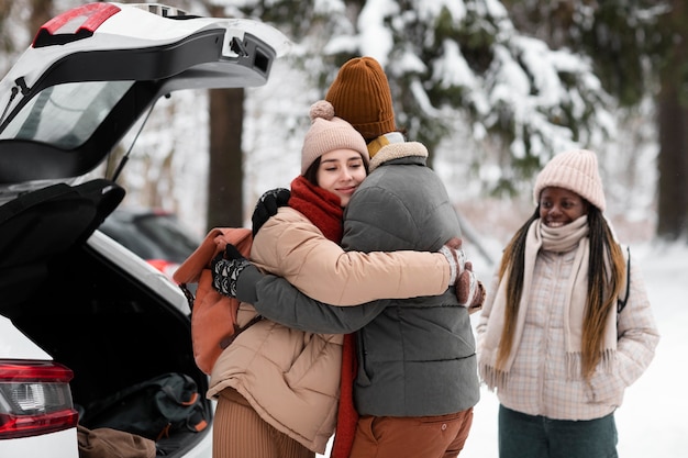 Medium shot friends hugging outdoors