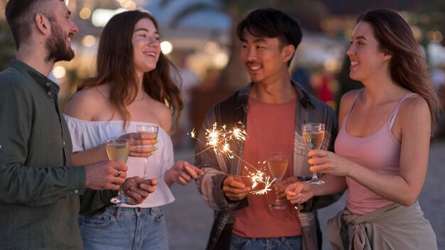 Medium shot friends partying with fireworks