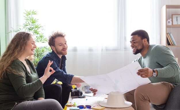 Medium shot friends planning trip at table