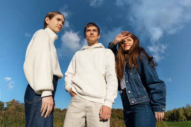 Medium shot friends posing outdoors