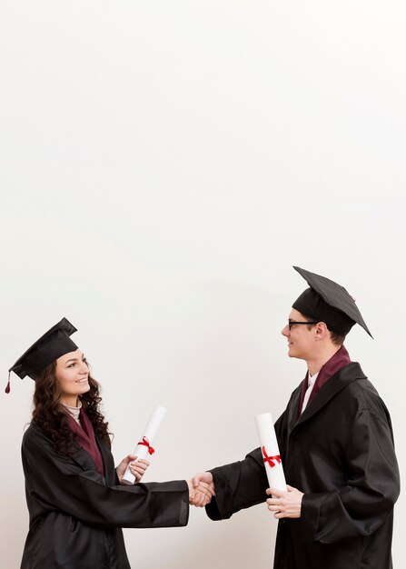 Medium shot friends shaking hands