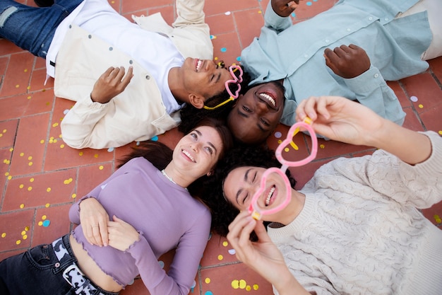 Medium shot friends sitting on floor