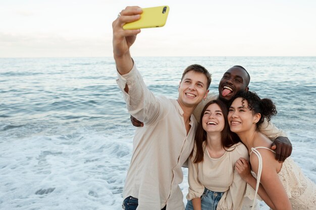 Medium shot friends taking selfie outside