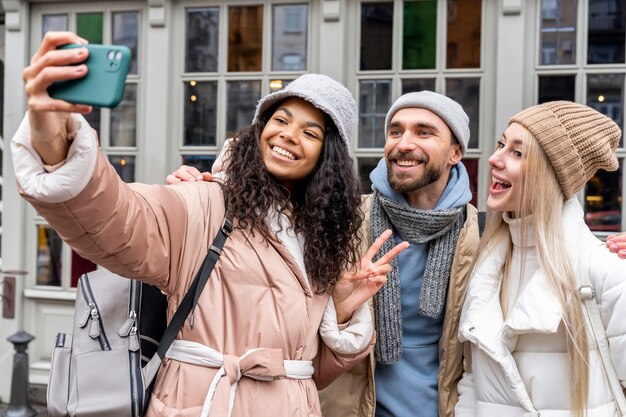 Medium shot friends taking selfie