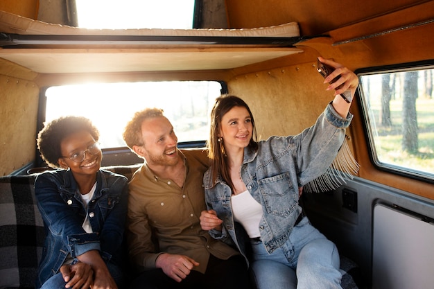 Medium shot friends taking selfie