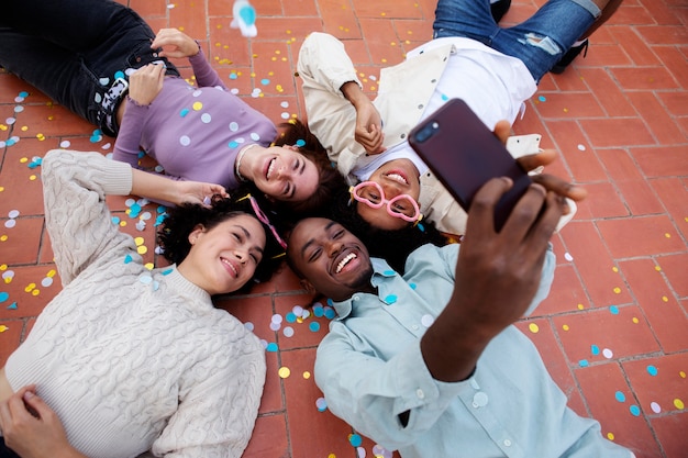 Medium shot friends taking selfie