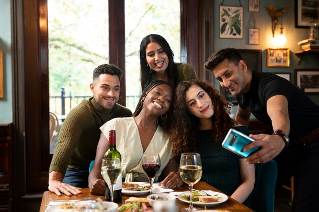 Medium shot friends taking selfie